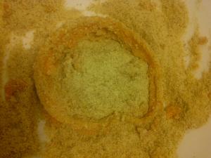 Rolling onion ring after bring battered into breadcrumb coating.